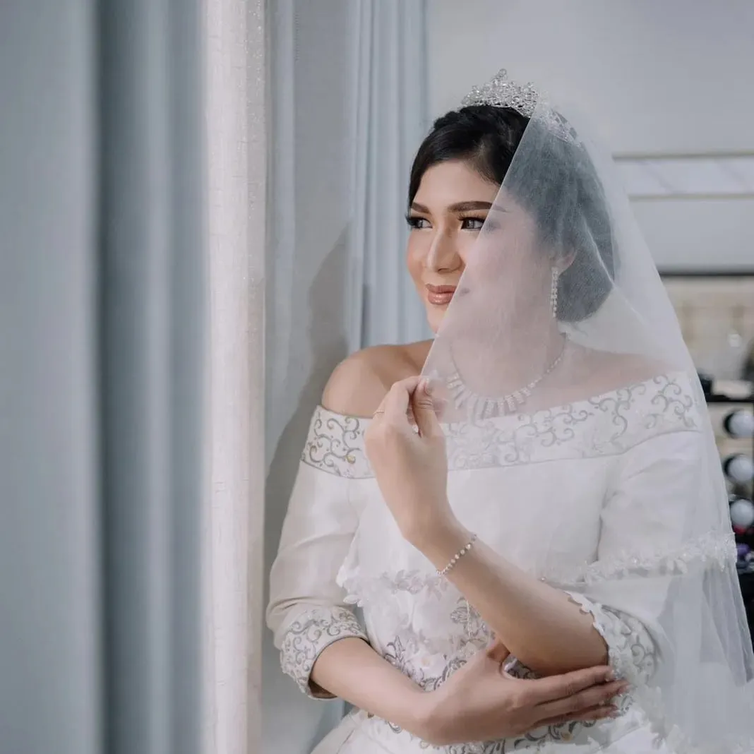 Pengantin wanita bergaun putih di balik veil
